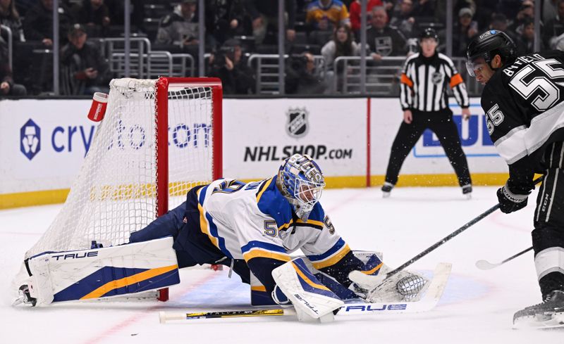 Mar 5, 2025; Los Angeles, California, USA;  St. Louis Blues goaltender Jordan Binnington (50) stops Los Angeles Kings right wing Quinton Byfield (55) during the overtime period at Crypto.com Arena. Mandatory Credit: Alex Gallardo-Imagn Images