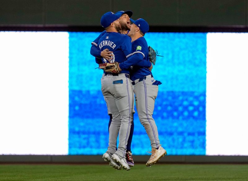 Apr 22, 2024; Kansas City, Missouri, USA; Toronto Blue Jays outfielder Kevin Kiermaier (39), outfielder George Springer (4) and outfielder Daulton Varsho (25) celebrate after defeating the Kansas City Royals at Kauffman Stadium. Mandatory Credit: Jay Biggerstaff-USA TODAY Sports