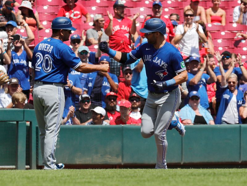 Aug 20, 2023; Cincinnati, Ohio, USA; Toronto Blue Jays center fielder Kevin Kiermaier (right) reacts with third base coach Luis Rivera (20) after hitting a two-run home run against the Cincinnati Reds during the second inning at Great American Ball Park. Mandatory Credit: David Kohl-USA TODAY Sports