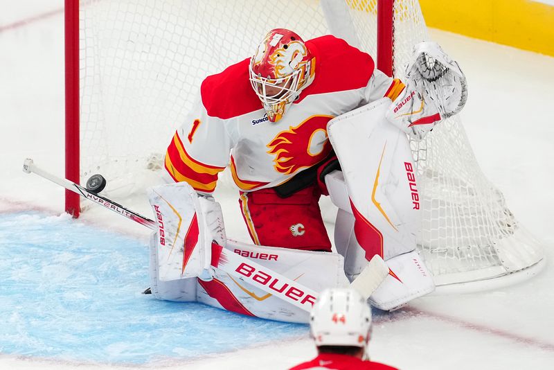 Oct 18, 2025; Las Vegas, Nevada, USA; Calgary Flames goaltender Devin Cooley (1) makes a save against the Vegas Golden Knights during the third period at T-Mobile Arena. Mandatory Credit: Stephen R. Sylvanie-Imagn Images