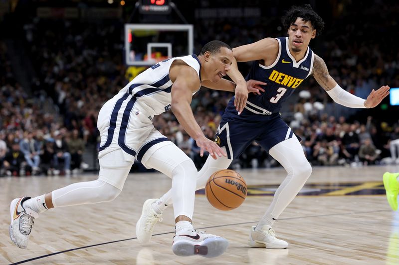 DENVER, COLORADO - DECEMBER 28: Desmond Bane #22 of the Memphis Grizzlies drives against Julian Strawther #3 of the Denver Nuggets in the third quarter at Ball Arena on December 28, 2023 in Denver, Colorado.  NOTE TO USER: User expressly acknowledges and agrees that, by downloading and or using this photograph, User is consenting to the terms and conditions of the Getty Images License Agreement.  (Photo by Matthew Stockman/Getty Images)