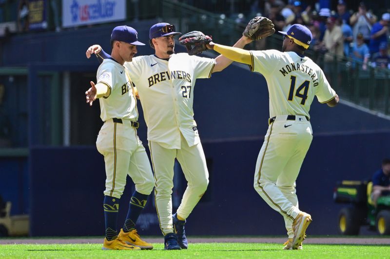 May 15, 2024; Milwaukee, Wisconsin, USA; Milwaukee Brewers second baseman Joey Ortiz (3), shortstop Willy Adames (27) and third baseman Andruw Monasterio (14) celebrate after beating the Pittsburgh Pirates at American Family Field. Mandatory Credit: Benny Sieu-USA TODAY Sports