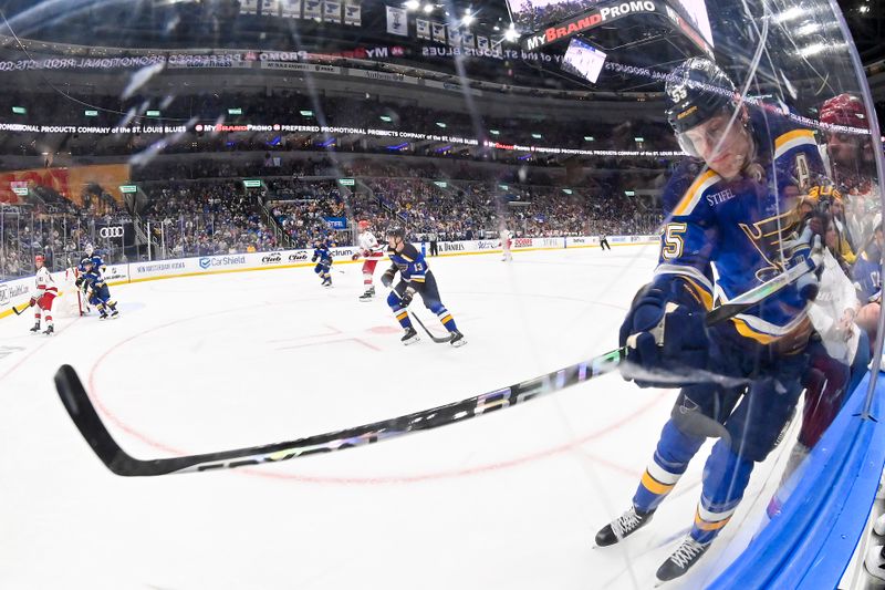 Apr 12, 2024; St. Louis, Missouri, USA;  St. Louis Blues defenseman Colton Parayko (55) checks Carolina Hurricanes left wing Jordan Martinook (48) during the third period at Enterprise Center. Mandatory Credit: Jeff Curry-USA TODAY Sports