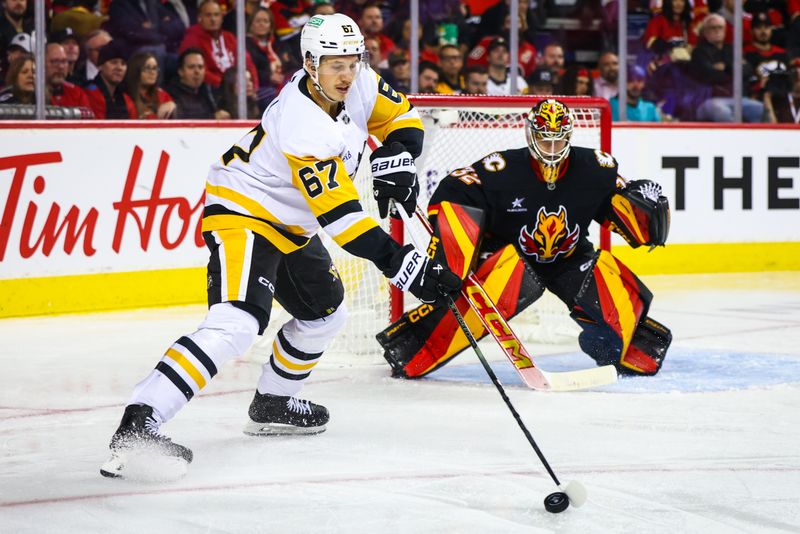 Oct 22, 2024; Calgary, Alberta, CAN; Pittsburgh Penguins right wing Rickard Rakell (67) controls the puck in front of Calgary Flames goaltender Dustin Wolf (32) during the third period at Scotiabank Saddledome. Mandatory Credit: Sergei Belski-Imagn Images