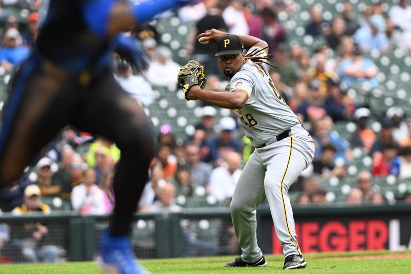 May 29, 2024; Detroit, Michigan, USA;  Pittsburgh Pirates pitcher Luis L. Ortiz (48) gets ready to throw to first to try and retire Detroit Tigers shortstop Javier Báez (28) on a weak ground ball in front of the mound in the sixth inning at Comerica Park. Ortiz made a throwing error on the play allowing Báez to go to second base. Mandatory Credit: Lon Horwedel-USA TODAY Sports