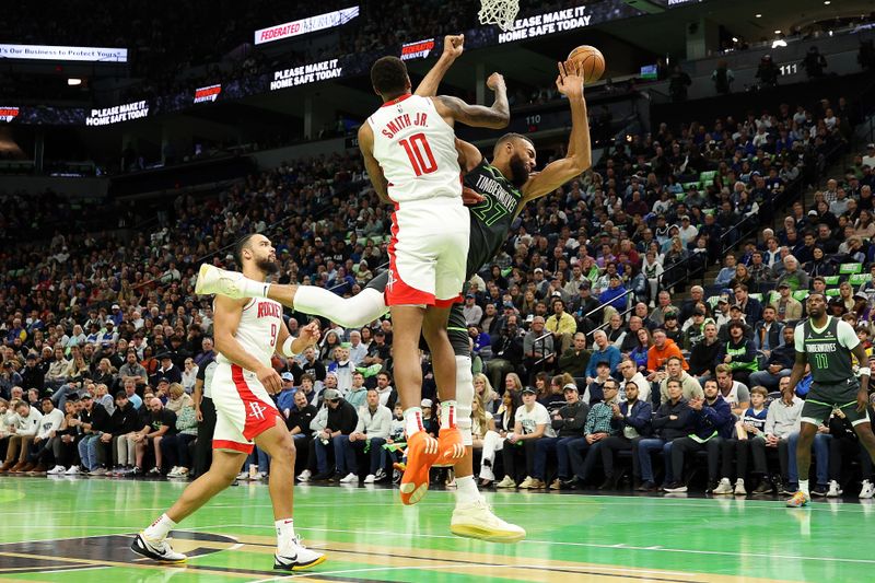 MINNEAPOLIS, MINNESOTA - NOVEMBER 26: Jabari Smith Jr. #10 of the Houston Rockets fouls Rudy Gobert #27 of the Minnesota Timberwolves in the first quarter during the Emirates NBA Cup at Target Center on November 26, 2024 in Minneapolis, Minnesota. NOTE TO USER: User expressly acknowledges and agrees that, by downloading and or using this photograph, User is consenting to the terms and conditions of the Getty Images License Agreement. (Photo by David Berding/Getty Images)