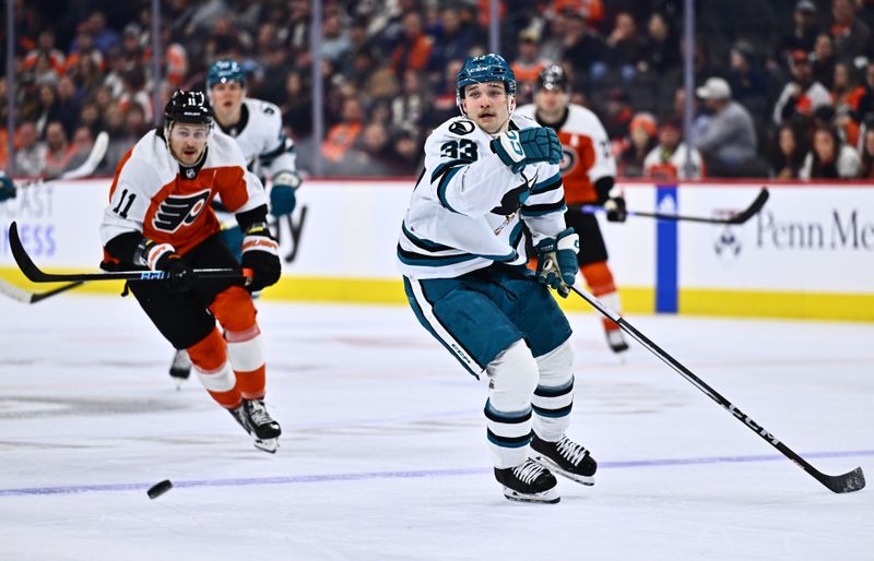 Mar 12, 2024; Philadelphia, Pennsylvania, USA; San Jose Sharks defenseman Calen Addison (33) chases a loose puck against the Philadelphia Flyers in the first period at Wells Fargo Center. Mandatory Credit: Kyle Ross-USA TODAY Sports