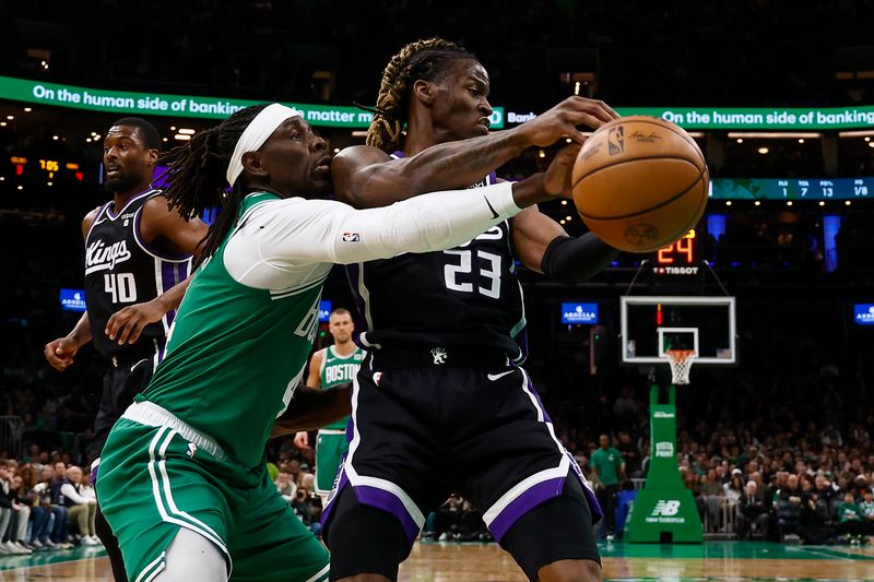 BOSTON, MA - APRIL 5: Jrue Holiday #4 of the Boston Celtics reaches in to knock the ball away from Keon Ellis #23 of the Sacramento Kings during the first quarter at TD Garden on April 5, 2024 in Boston, Massachusetts. NOTE TO USER: User expressly acknowledges and agrees that, by downloading and/or using this Photograph, user is consenting to the terms and conditions of the Getty Images License Agreement. (Photo By Winslow Townson/Getty Images)