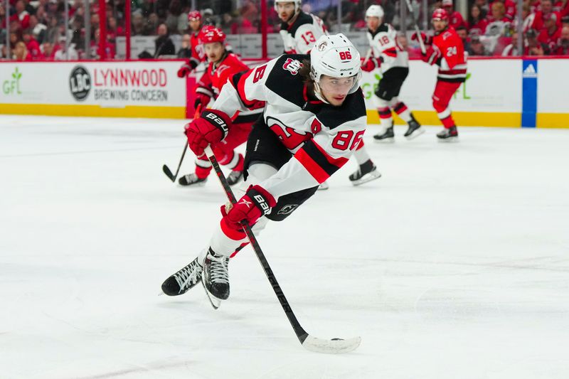 May 11, 2023; Raleigh, North Carolina, USA; New Jersey Devils center Jack Hughes (86) skates with the puck against the Carolina Hurricanes during the first period in game five of the second round of the 2023 Stanley Cup Playoffs at PNC Arena. Mandatory Credit: James Guillory-USA TODAY Sports