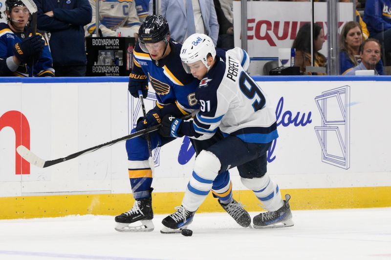 Oct 22, 2024; St. Louis, Missouri, USA; Winnipeg Jets center Cole Perfetti (91) battles St. Louis Blues center Dylan Holloway (81) during the first period at Enterprise Center. Mandatory Credit: Jeff Le-Imagn Images 