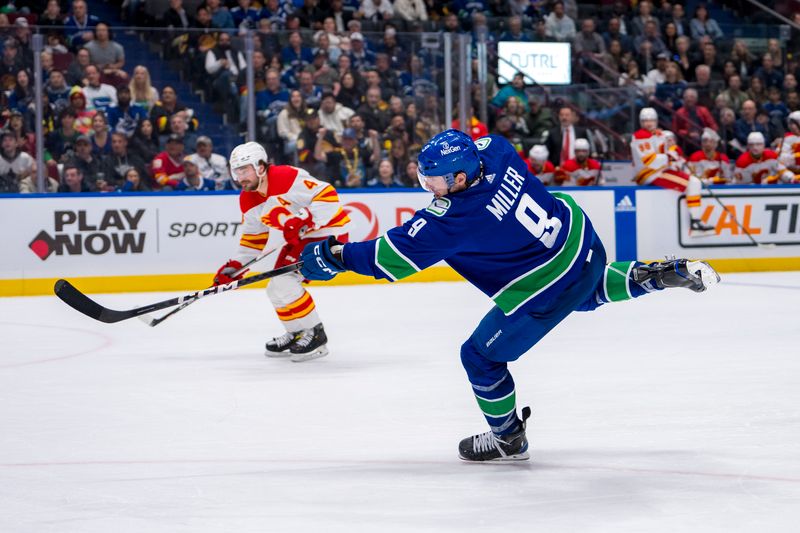 Apr 16, 2024; Vancouver, British Columbia, CAN; Vancouver Canucks forward J.T. Miller (9) scores on this shot against the Calgary Flames in the third period at Rogers Arena. Canucks won 4 -1. Mandatory Credit: Bob Frid-USA TODAY Sports