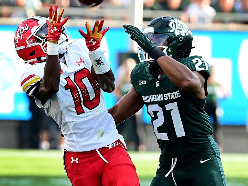 Sep 23, 2023; East Lansing, Michigan, USA;  Maryland Terrapins wide receiver Tai Felton (10) pulls in a pass in spite of Michigan State Spartans defensive back Dillon Tatum (21) in the third quarter at Spartan Stadium. Mandatory Credit: Dale Young-USA TODAY Sports