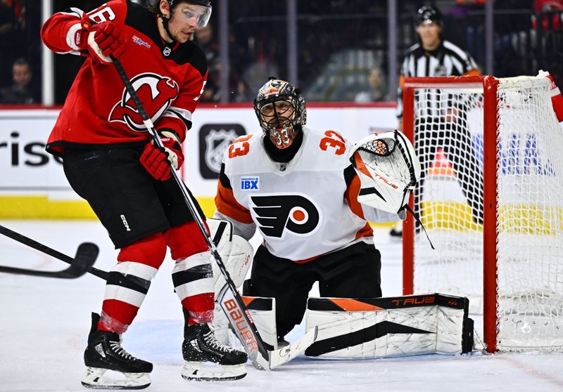 Apr 13, 2024; Philadelphia, Pennsylvania, USA; Philadelphia Flyers goalie Samuel Ersson (33) defends the net against New Jersey Devils left wing Erik Haula (56) in the second period at Wells Fargo Center. Mandatory Credit: Kyle Ross-USA TODAY Sports