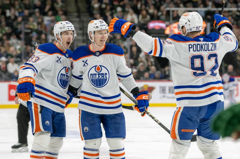 Jan 15, 2025; Saint Paul, Minnesota, USA;  Edmonton Oilers forward Ryan Nugent-Hopkins (93) celebrates his goal against the Minnesota Wild defenseman Ty Emberson (49) and forward Vasily Podkolzin (92) during the second period at Xcel Energy Center. Mandatory Credit: Nick Wosika-Imagn Images

