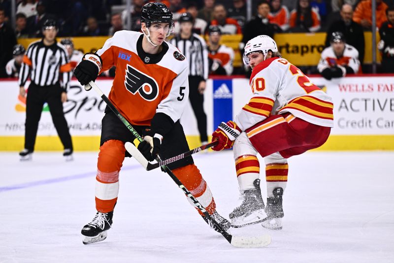 Jan 6, 2024; Philadelphia, Pennsylvania, USA; Philadelphia Flyers defenseman Egor Zamula (5) battles for position against Calgary Flames center Blake Coleman (20) in the second period at Wells Fargo Center. Mandatory Credit: Kyle Ross-USA TODAY Sports