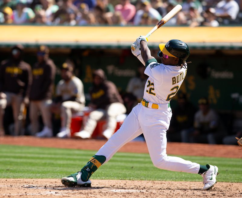 Sep 16, 2023; Oakland, California, USA; Oakland Athletics center fielder Lawrence Butler (22) follows through on his single against the San Diego Padres during the fourth inning at Oakland-Alameda County Coliseum. Mandatory Credit: D. Ross Cameron-USA TODAY Sports