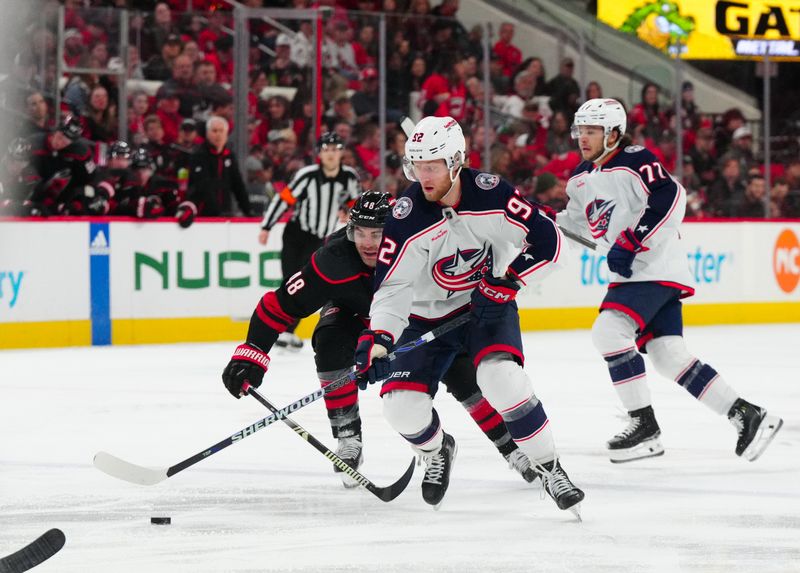 Apr 7, 2024; Raleigh, North Carolina, USA;  Columbus Blue Jackets left wing Alexander Nylander (92) skates with the puck past Carolina Hurricanes left wing Jordan Martinook (48) during the second period at PNC Arena. Mandatory Credit: James Guillory-USA TODAY Sports