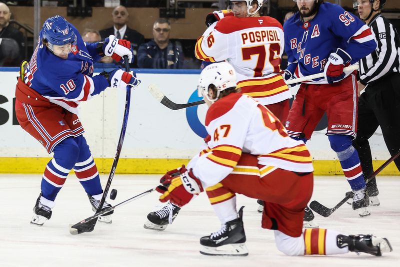Mar 18, 2025; New York, New York, USA;  New York Rangers left wing Artemi Panarin (10) attempts to shoot past Calgary Flames center Connor Zary (47) in the third period at Madison Square Garden. Mandatory Credit: Wendell Cruz-Imagn Images