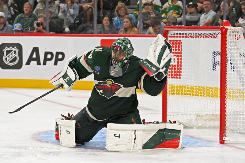 Sep 27, 2024; Saint Paul, Minnesota, USA;  Minnesota Wild goalie Marc-Andre Fleury (29) makes a glove-save against the Winnipeg Jets during the third period at Xcel Energy Center. Mandatory Credit: Nick Wosika-Imagn Images

