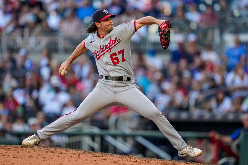 Oct 1, 2023; Cumberland, Georgia, USA; Washington Nationals relief pitcher Kyle Finnegan (67) pitches against the Atlanta Braves during the ninth inning at Truist Park. Mandatory Credit: Dale Zanine-USA TODAY Sports