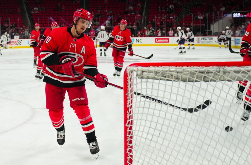 Nov 26, 2023; Raleigh, North Carolina, USA; Carolina Hurricanes center Sebastian Aho (20) takes a shot in the warmups against the Columbus Blue Jackets at PNC Arena. Mandatory Credit: James Guillory-USA TODAY Sports