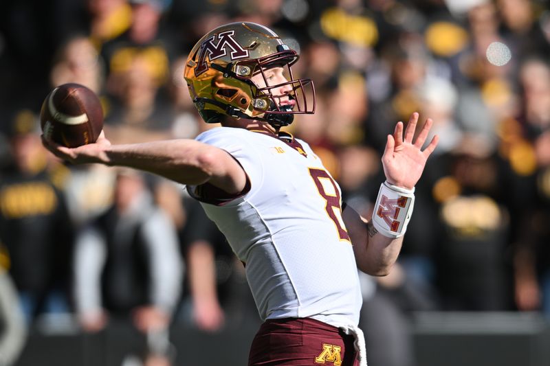 Oct 21, 2023; Iowa City, Iowa, USA; Minnesota Golden Gophers quarterback Athan Kaliakmanis (8) throws a pass against the Iowa Hawkeyes during the first quarter at Kinnick Stadium. Mandatory Credit: Jeffrey Becker-USA TODAY Sports