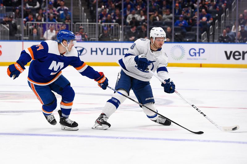 Apr 6, 2023; Elmont, New York, USA; New York Islanders center Jean-Gabriel Pageau (44) defends against Tampa Bay Lightning defenseman Mikhail Sergachev (98) during the first period at UBS Arena. Mandatory Credit: Dennis Schneidler-USA TODAY Sports