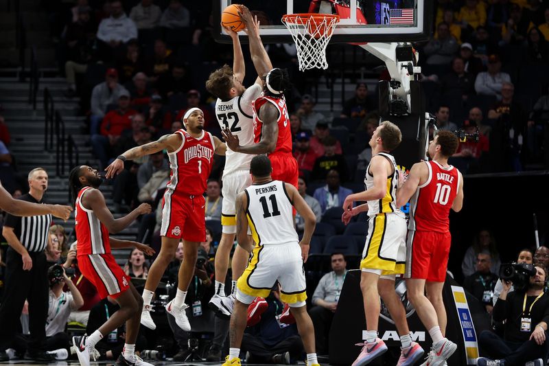 Mar 14, 2024; Minneapolis, MN, USA; Ohio State Buckeyes center Felix Okpara (34) blocks a shot by Iowa Hawkeyes forward Owen Freeman (32) during the second half at Target Center. Mandatory Credit: Matt Krohn-USA TODAY Sports