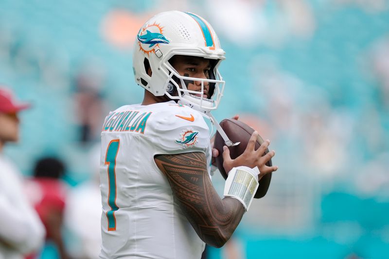 Miami Dolphins quarterback Tua Tagovailoa (1) warms up before an NFL football game against the Arizona Cardinals, Sunday, Oct. 27, 2024, in Miami Gardens, Fla. (AP Photo/Rebecca Blackwell)