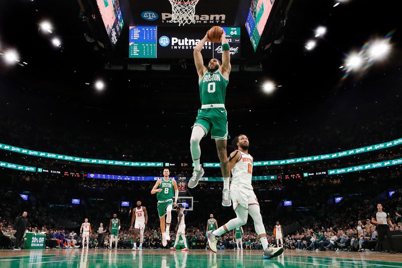 BOSTON, MA - DECEMBER 8: Jayson Tatum #0 of the Boston Celtics goes in for a dunk past Jalen Brunson #11 of the New York Knicks during the second quarter at TD Garden on December 8, 2023 in Boston, Massachusetts. NOTE TO USER: User expressly acknowledges and agrees that, by downloading and/or using this Photograph, user is consenting to the terms and conditions of the Getty Images License Agreement. (Photo By Winslow Townson/Getty Images)