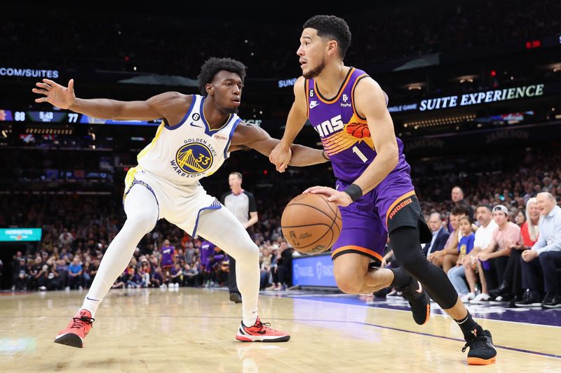 PHOENIX, ARIZONA - OCTOBER 25: Devin Booker #1 of the Phoenix Suns drives the ball against James Wiseman #33 of the Golden State Warriors during the second half of the NBA game at Footprint Center on October 25, 2022 in Phoenix, Arizona. The Suns defeated the Warriors 134-105. NOTE TO USER: User expressly acknowledges and agrees that, by downloading and or using this photograph, User is consenting to the terms and conditions of the Getty Images License Agreement.  (Photo by Christian Petersen/Getty Images)