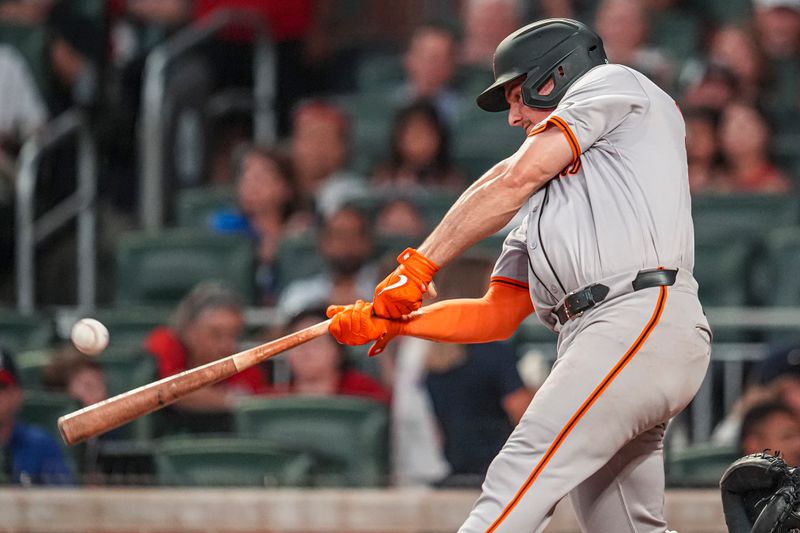 Jul 3, 2024; Cumberland, Georgia, USA; San Francisco Giants third baseman Matt Chapman (26) hits a double to drive in a run against the Atlanta Braves during the sixth inning at Truist Park. Mandatory Credit: Dale Zanine-USA TODAY Sports