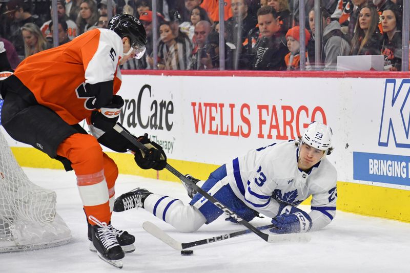 Mar 14, 2024; Philadelphia, Pennsylvania, USA; Toronto Maple Leafs left wing Matthew Knies (23) and Philadelphia Flyers defenseman Egor Zamula (5) battle for the puck during the second period at Wells Fargo Center. Mandatory Credit: Eric Hartline-USA TODAY Sports