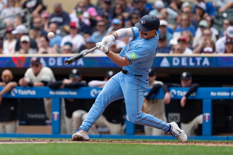 Jun 8, 2025; Minneapolis, Minnesota, USA; Toronto Blue Jays left fielder Alan Roden (18) hits an RBI double during the second inning against the Minnesota Twins at Target Field. Mandatory Credit: Jordan Johnson-Imagn Images