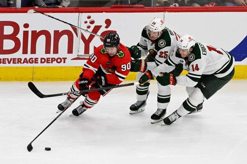 Apr 7, 2024; Chicago, Illinois, USA;  Chicago Blackhawks center Tyler Johnson (90) moves the puck away from Minnesota Wild defenseman Jonas Brodin (25) and center Joel Eriksson Ek (14) during the second period at United Center. Mandatory Credit: Matt Marton-USA TODAY Sports