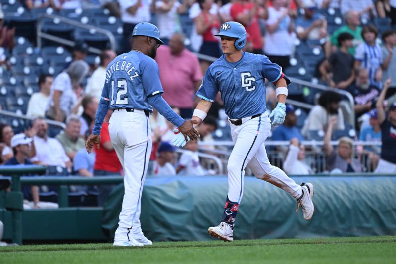 Jun 6, 2025; Washington, District of Columbia, USA; Washington Nationals right fielder Alex Call (17) celebrates hitting a home run with third base coach Ricky Gutierrez (12) during the seventh inning against the Texas Rangers at Nationals Park. Mandatory Credit: Rafael Suanes-Imagn Images