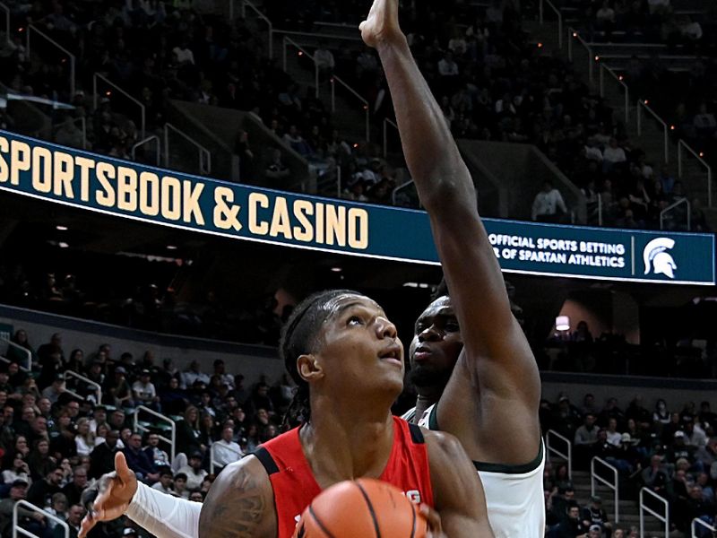 Feb 7, 2023; East Lansing, Michigan, USA;  Maryland Terrapins forward Julian Reese (10) looks for a shot under the basket against Michigan State Spartans center Mady Sissoko (22) in the first half at Jack Breslin Student Events Center. Mandatory Credit: Dale Young-USA TODAY Sports