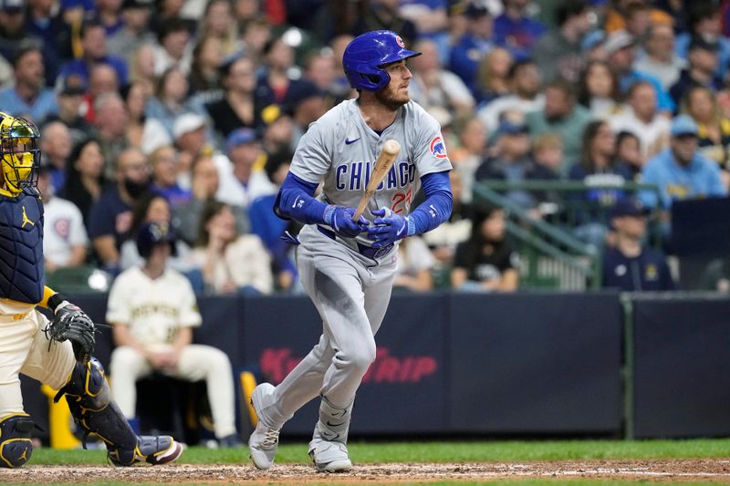 May 28, 2024; Milwaukee, Wisconsin, USA;  Chicago Cubs center fielder Cody Bellinger (24) singles during the sixth inning against the Milwaukee Brewers at American Family Field. Mandatory Credit: Jeff Hanisch-USA TODAY Sports