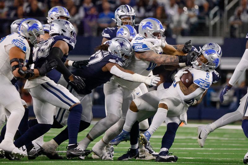 Dallas Cowboys defensive end Dorance Armstrong, back right, tackles Detroit Lions running back David Montgomery (5) during the second half of an NFL football game, Saturday, Dec. 30, 2023, in Arlington, Texas. (AP Photo/Michael Ainsworth)