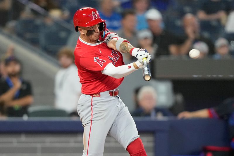 Aug 23, 2024; Toronto, Ontario, CAN; Los Angeles Angels shortstop Zach Neto (9) hits a single against the Toronto Blue Jays during the eighth inning at Rogers Centre. Mandatory Credit: John E. Sokolowski-USA TODAY Sports