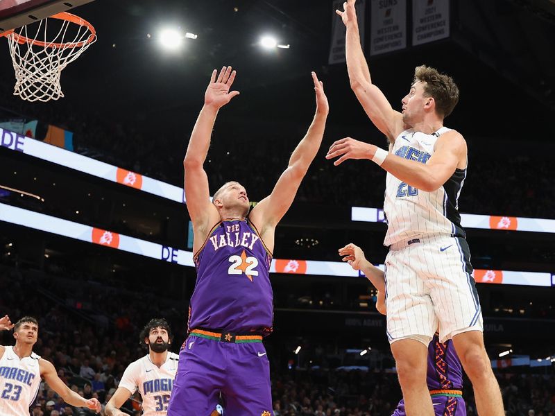 PHOENIX, ARIZONA - NOVEMBER 18: Franz Wagner #22 of the Orlando Magic attempts a shot over Mason Plumlee #22 of the Phoenix Suns during the first half of the NBA game at Footprint Center on November 18, 2024 in Phoenix, Arizona.  NOTE TO USER: User expressly acknowledges and agrees that, by downloading and/or using this photograph, user is consenting to the terms and conditions of the Getty Images License Agreement. (Photo by Christian Petersen/Getty Images)