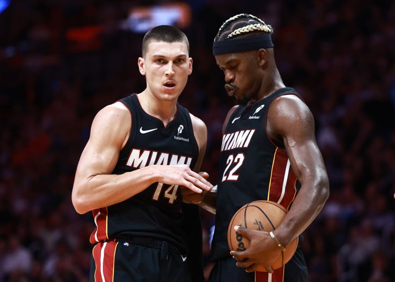 MIAMI, FLORIDA - NOVEMBER 04: Jimmy Butler #22 of the Miami Heat high fives Tyler Herro #14  after he makes his free throw against the Sacramento Kings during the second half at Kaseya Center on November 04, 2024 in Miami, Florida. NOTE TO USER: User expressly acknowledges and agrees that, by downloading and or using this Photograph, user is consenting to the terms and conditions of the Getty Images License Agreement. (Photo by Carmen Mandato/Getty Images)