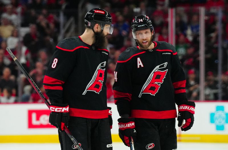 May 16, 2024; Raleigh, North Carolina, USA; ICarolina Hurricanes defenseman Brent Burns (8) and Carolina Hurricanes defenseman Jaccob Slavin (74) talk against the New York Rangers during the second period n game six of the second round of the 2024 Stanley Cup Playoffs at PNC Arena. Mandatory Credit: James Guillory-USA TODAY Sports