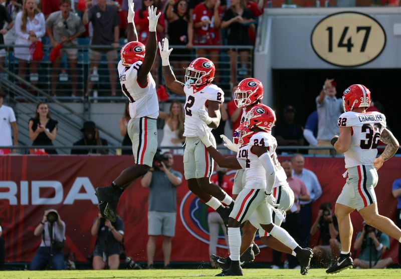 Oct 28, 2023; Jacksonville, Florida, USA; Georgia Bulldogs linebacker Smael Mondon Jr. (2) celebrates with linebacker Jalon Walker (11) during the first half against the Florida Gators at EverBank Stadium. Mandatory Credit: Kim Klement Neitzel-USA TODAY Sports