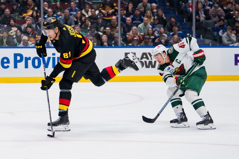 Dec 7, 2023; Vancouver, British Columbia, CAN; Minnesota Wild defenseman Jared Spurgeon (46) watches as Vancouver Canucks forward Dakota Joshua (81) prepares to shoot on a breakaway in the third period at Rogers Arena. Vancouver won 2-0.  Mandatory Credit: Bob Frid-USA TODAY Sports