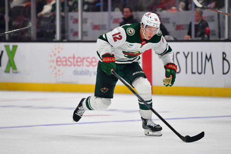 Dec 6, 2024; Anaheim, California, USA; Minnesota Wild left wing Matt Boldy (12) moves the puck against the Anaheim Ducks during the third period at Honda Center. Mandatory Credit: Gary A. Vasquez-Imagn Images