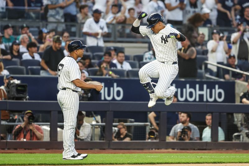 May 22, 2024; Bronx, New York, USA;  New York Yankees right fielder Juan Soto (22) celebrates with third base coach Luis Rojas (67) after hitting a two-run home run in the third inning against the Seattle Mariners at Yankee Stadium. Mandatory Credit: Wendell Cruz-USA TODAY Sports