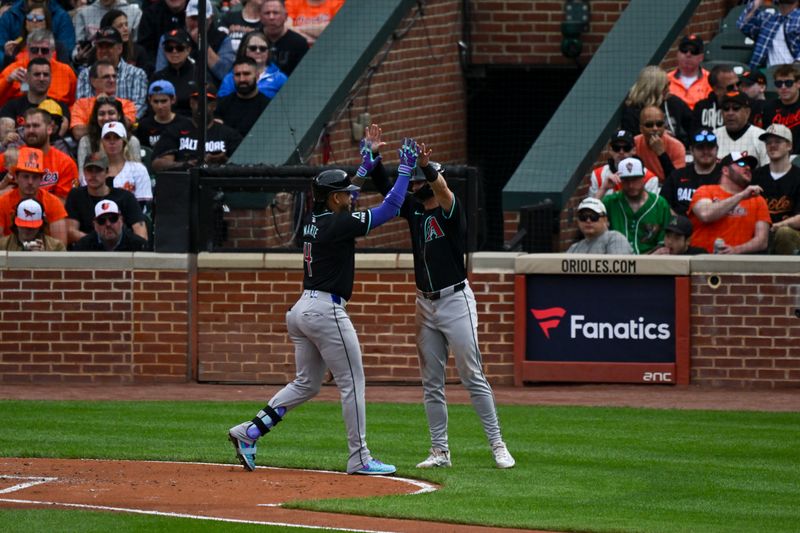 May 11, 2024; Baltimore, Maryland, USA;  Arizona Diamondbacks second baseman Ketel Marte (4) celebrates with outfielder Corbin Carroll (7) after hitting a third inning solo home run against the Baltimore Orioles at Oriole Park at Camden Yards. Mandatory Credit: Tommy Gilligan-USA TODAY Sports