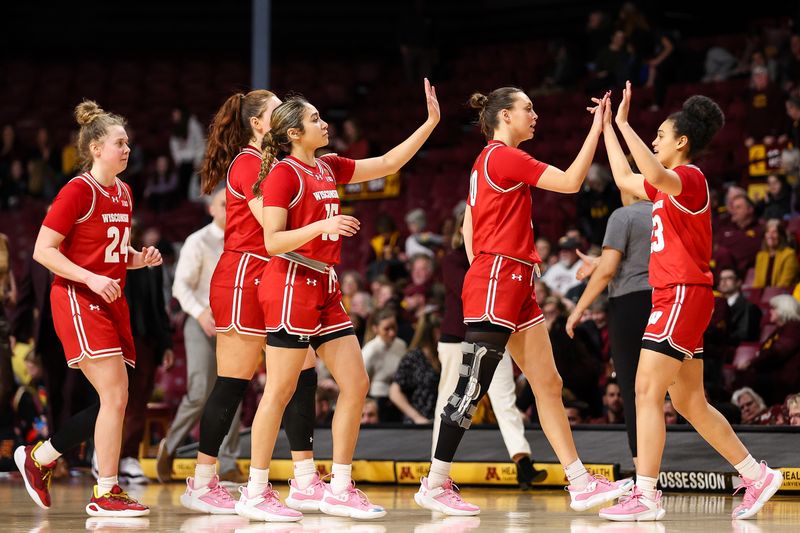 Feb 20, 2024; Minneapolis, Minnesota, USA; Wisconsin Badgers players celebrate the win against the Minnesota Golden Gophers during the second half at Williams Arena. Mandatory Credit: Matt Krohn-USA TODAY Sports