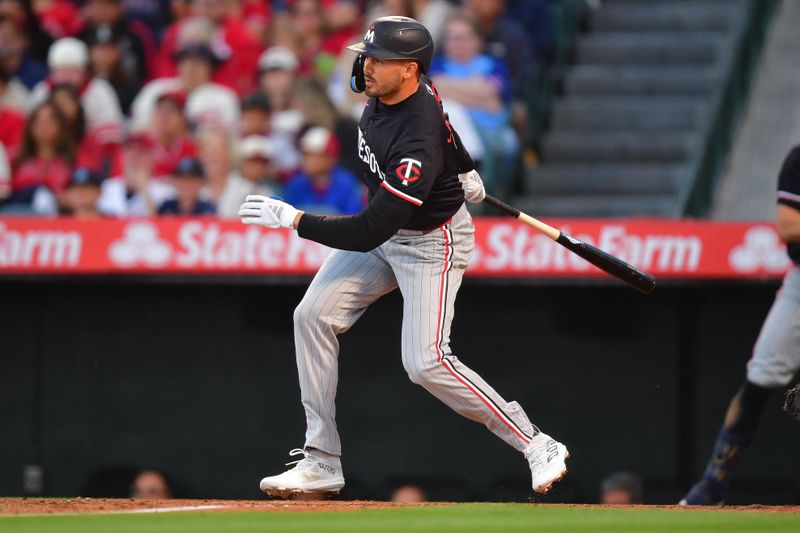 Apr 27, 2024; Anaheim, California, USA; Minnesota Twins designated hitter Trevor Larnach (9) hits an RBI single against the Los Angeles Angels during the second inning at Angel Stadium. Mandatory Credit: Gary A. Vasquez-USA TODAY Sports